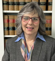 Edith L. Curry in front of law books