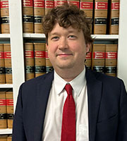 Justin Geyer in front of law books