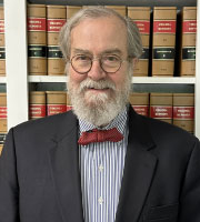 Richard J. Knapp in front of law books
